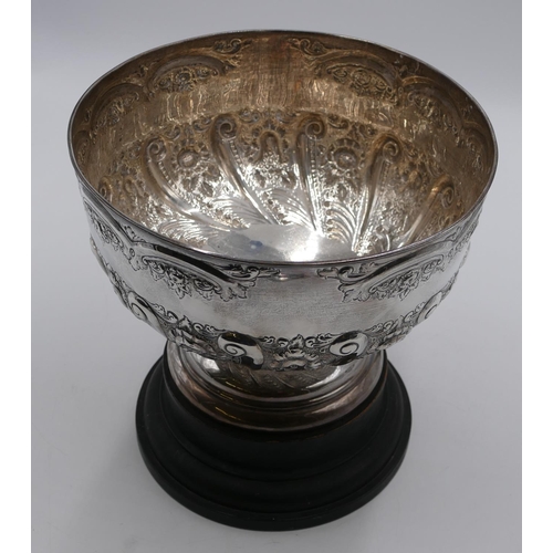 248 - A late Victorian silver punch bowl with allover embossed floral, leaf and scroll decoration, sweepin... 