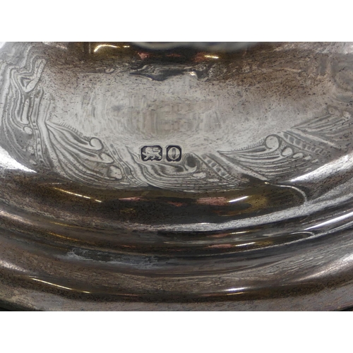 248 - A late Victorian silver punch bowl with allover embossed floral, leaf and scroll decoration, sweepin... 