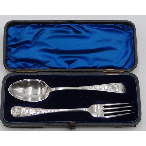 252 - A pair of Sheffield silver child's fork and spoon with engraved leaf and scroll decoration, in fitte... 