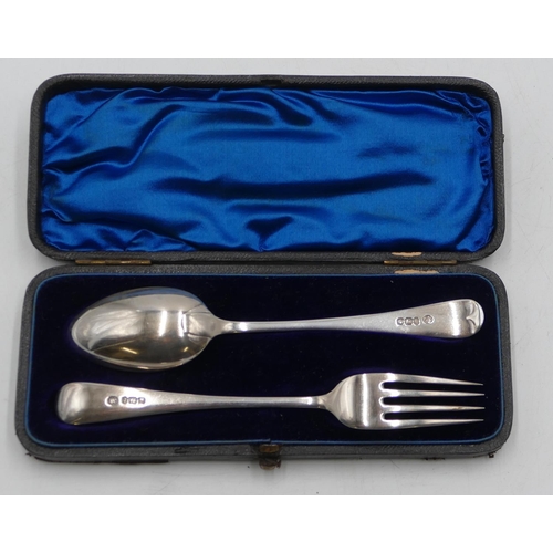 252 - A pair of Sheffield silver child's fork and spoon with engraved leaf and scroll decoration, in fitte... 