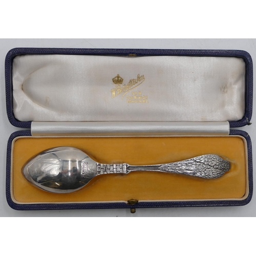 253 - A George V silver child's birth spoon with stalk shaped handle holding a child, bowl engraved with c... 