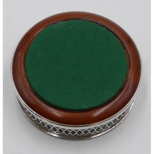 259 - A modern London silver wine coaster with pierced rim and wooden centre, 13cm diameter.