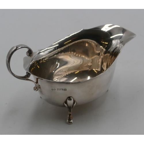 260 - A Birmingham silver sauce boat with crinkle rim, scroll handle on splayed feet, 3.9oz.