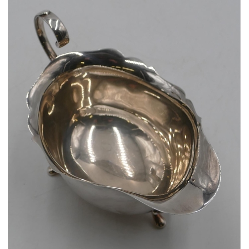 260 - A Birmingham silver sauce boat with crinkle rim, scroll handle on splayed feet, 3.9oz.