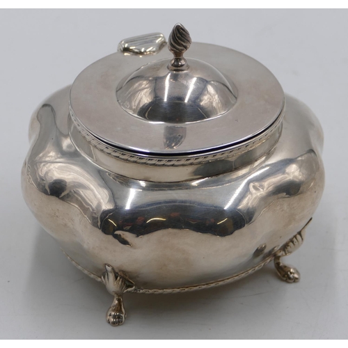 265 - A Birmingham silver bulbous shaped caddy with hinged lid and allover embossed decoration on splayed ... 