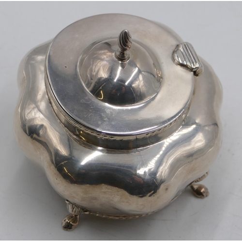 265 - A Birmingham silver bulbous shaped caddy with hinged lid and allover embossed decoration on splayed ... 