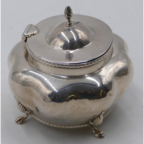 265 - A Birmingham silver bulbous shaped caddy with hinged lid and allover embossed decoration on splayed ... 