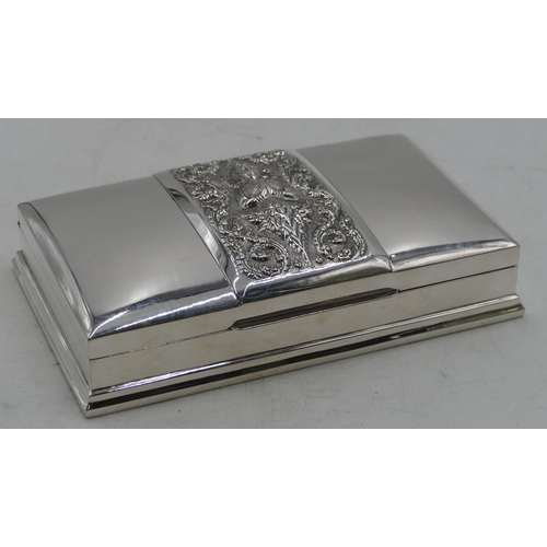 269 - A Siamese silver-coloured metal rectangular cigarette box, having hinged lid embossed with figure an... 