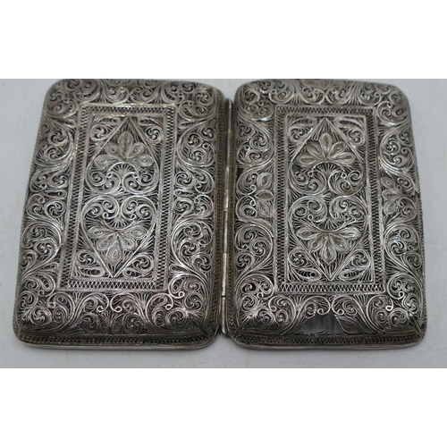 271 - A filigree silver-coloured metal card case with allover pierced, floral and leaf decoration (part da... 