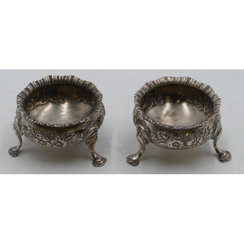 274 - A pair of Birmingham silver round bulbous shaped salts with crinkled rims and allover embossed flora... 