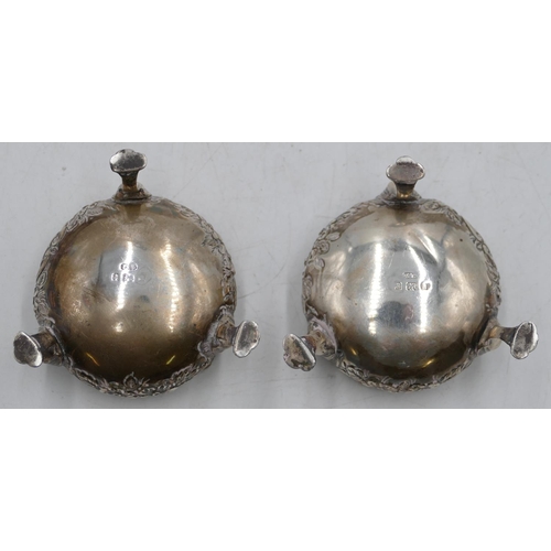 274 - A pair of Birmingham silver round bulbous shaped salts with crinkled rims and allover embossed flora... 