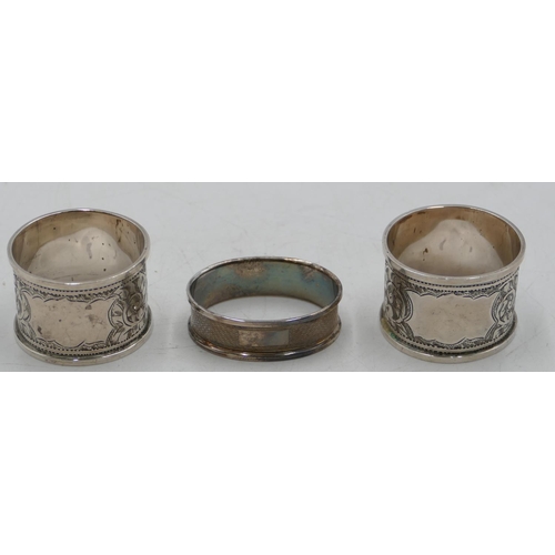 281 - A pair of Birmingham silver round napkin rings with allover chased leaf and scroll decoration and an... 