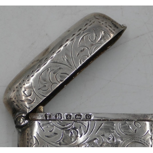 283 - A Birmingham silver concave shaped Vesta case with chased leaf and scroll decoration, hinged lid (sl... 