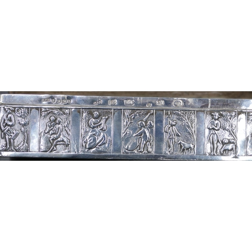 295 - A Dutch silver-coloured metal rectangular shaped box with hinged lid and allover embossed figure, cu... 