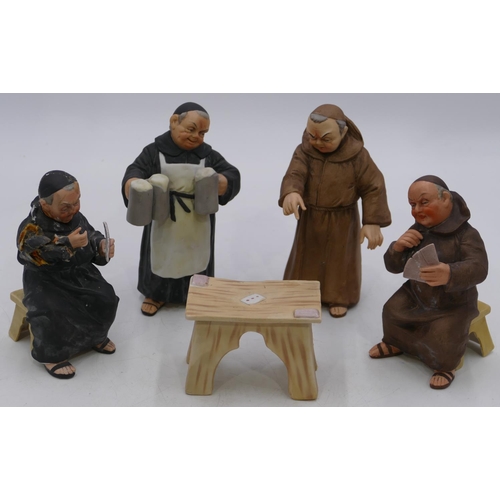 3 - 4 Continental china figures of 4 monks standing and seated around a table (1 seated monk badly a/f a... 