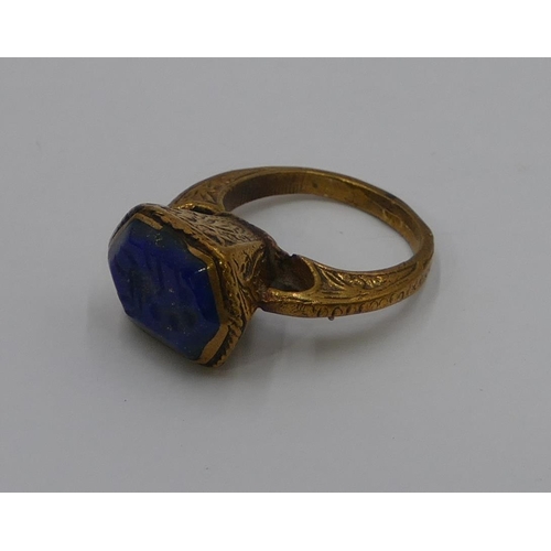 307 - A Roman style gilt ring etched with blue stone and engraved with a scorpion. Size O