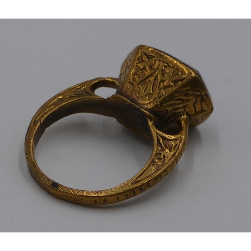 307 - A Roman style gilt ring etched with blue stone and engraved with a scorpion. Size O