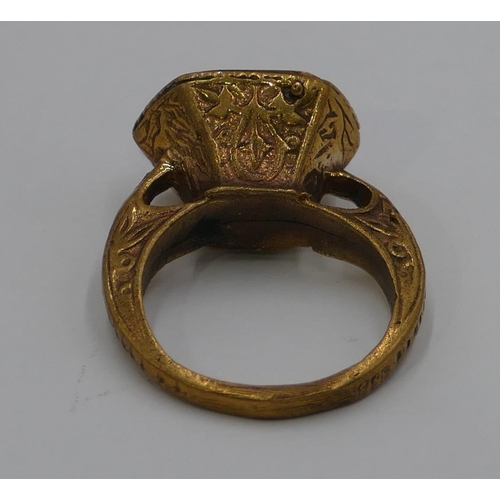 307 - A Roman style gilt ring etched with blue stone and engraved with a scorpion. Size O