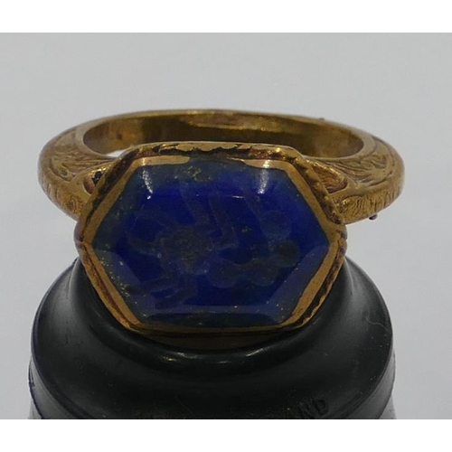 307 - A Roman style gilt ring etched with blue stone and engraved with a scorpion. Size O