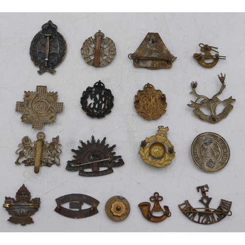 318 - An early oval flying cap badge, an Australian Commonwealth military forces cap badge, a South Africa... 