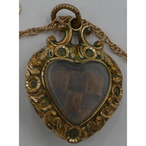 329 - A 9ct gold chain mounted with heart shaped mourning pendant with embossed decoration.