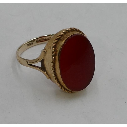 337 - A 9ct gold ladies' oval ring set with red stone, size P, 3.7 grams gross.