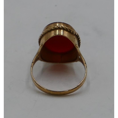 337 - A 9ct gold ladies' oval ring set with red stone, size P, 3.7 grams gross.