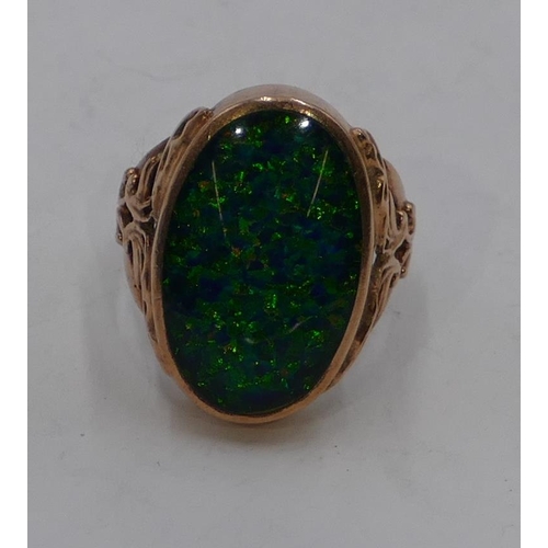 338 - A 9ct gold oval opal ring with pierced and embossed shoulders, size P/Q, 9.5 grams gross.