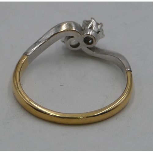 344 - An 18ct gold twist ring set with 2 diamonds approx. 0.15ct, size Q, 3.2 grams gross.