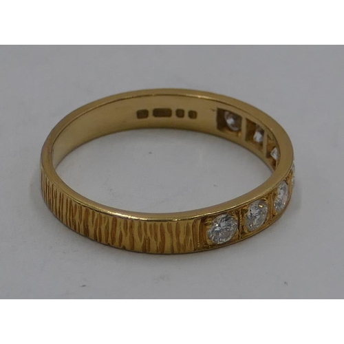 345 - An 18ct gold half eternity ring set with 7 diamonds, size O, 2.7 grams gross.