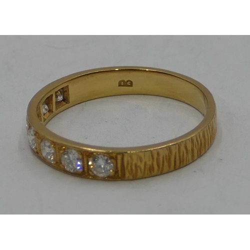 345 - An 18ct gold half eternity ring set with 7 diamonds, size O, 2.7 grams gross.