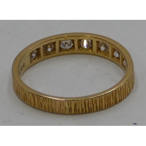 345 - An 18ct gold half eternity ring set with 7 diamonds, size O, 2.7 grams gross.