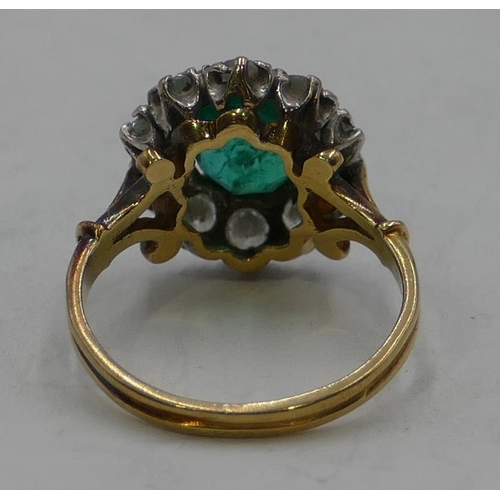 346 - An 18ct gold ladies' cluster ring set with centre emerald and surrounded by 10 diamonds, size N.