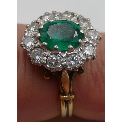 346 - An 18ct gold ladies' cluster ring set with centre emerald and surrounded by 10 diamonds, size N.