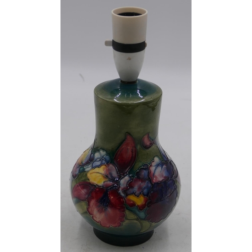 35 - A Moorcroft round bulbous thin necked table lamp on green ground with multicoloured floral and leaf ... 