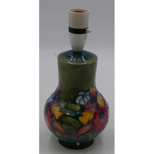 35 - A Moorcroft round bulbous thin necked table lamp on green ground with multicoloured floral and leaf ... 