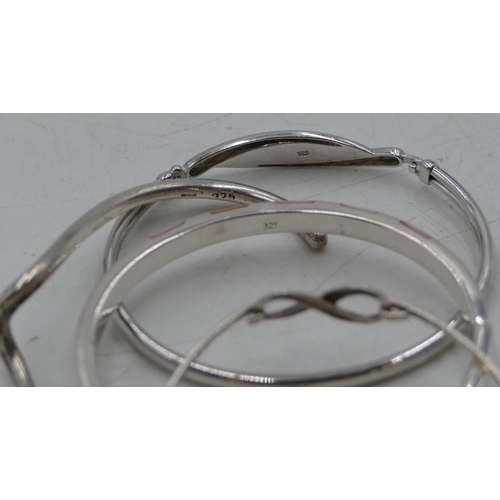 356 - 4 various silver bangles, 84.4 grams. (4)