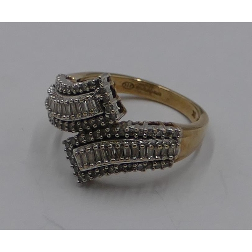 364 - A 9ct gold ladies twist ring set with small baguette diamonds, size M/N, 3.3 grams gross.