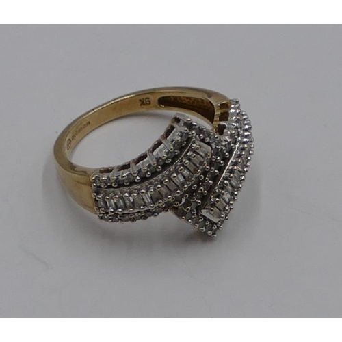 364 - A 9ct gold ladies twist ring set with small baguette diamonds, size M/N, 3.3 grams gross.