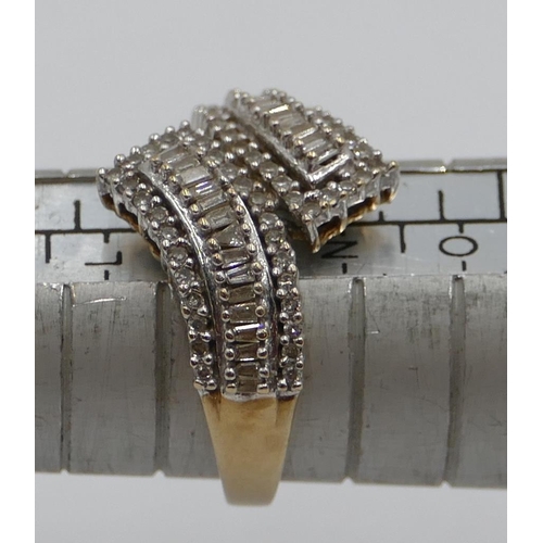 364 - A 9ct gold ladies twist ring set with small baguette diamonds, size M/N, 3.3 grams gross.