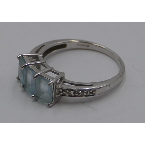 367 - A 9ct gold white gold ladies' ring set with 3 pale blue stones and flanked by small diamond chips, s... 