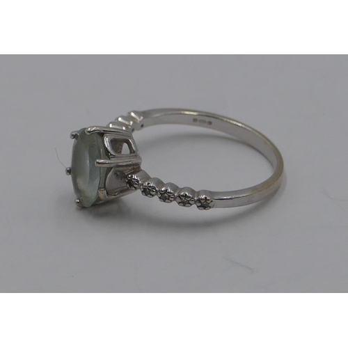 368 - A 9ct white gold ladies' ring set with pale blue stones and surrounded by small diamond chips, size ... 