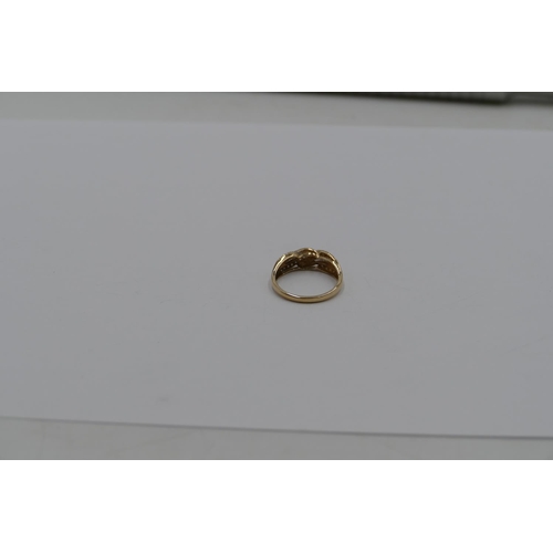 369 - A 9ct gold twist ring mounted with row of small diamonds, size T/U, 3. grams gross.