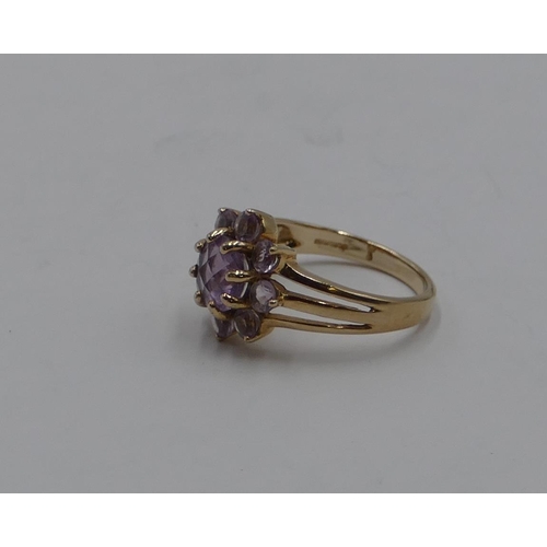 375 - A 9ct gold ladies' cluster ring set with pale purple stones, size N/O, 3.3 grams.