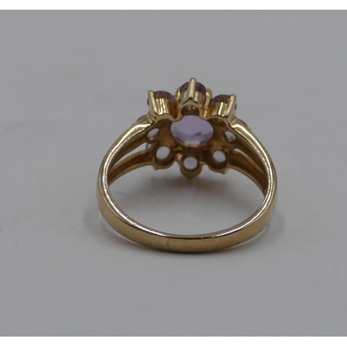 375 - A 9ct gold ladies' cluster ring set with pale purple stones, size N/O, 3.3 grams.