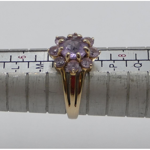 375 - A 9ct gold ladies' cluster ring set with pale purple stones, size N/O, 3.3 grams.