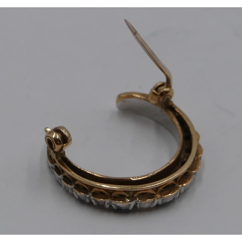 378 - A 9ct gold crescent moon brooch wet with 7 sapphires and interspersed by diamonds, 2.5cm wide, 5.1 g... 