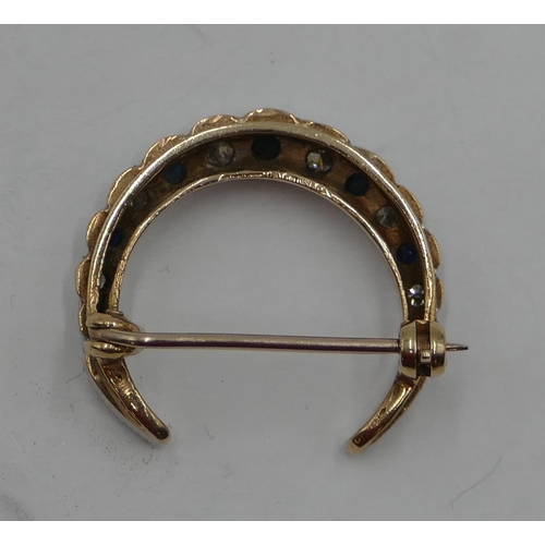 378 - A 9ct gold crescent moon brooch wet with 7 sapphires and interspersed by diamonds, 2.5cm wide, 5.1 g... 