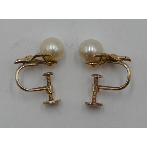 379 - A pair of 14ct gold and cultured pearls screw back earrings, 2.9 grams gross.