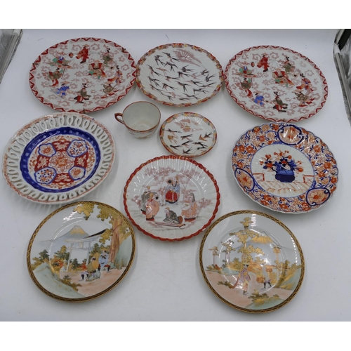 38 - An Imari round scallop shaped plate on white, red and blue ground with vase, floral and scroll decor... 